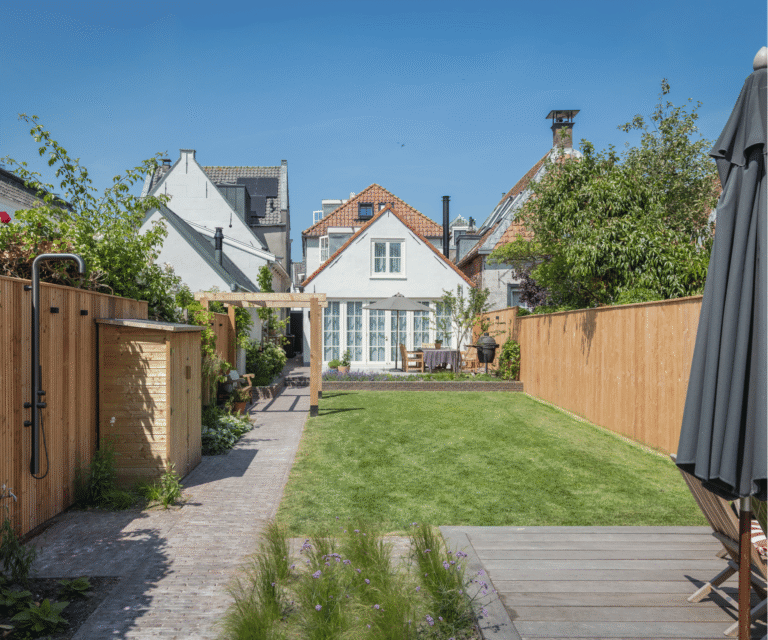 Luxe achtertuin met gras, looppad en pergola